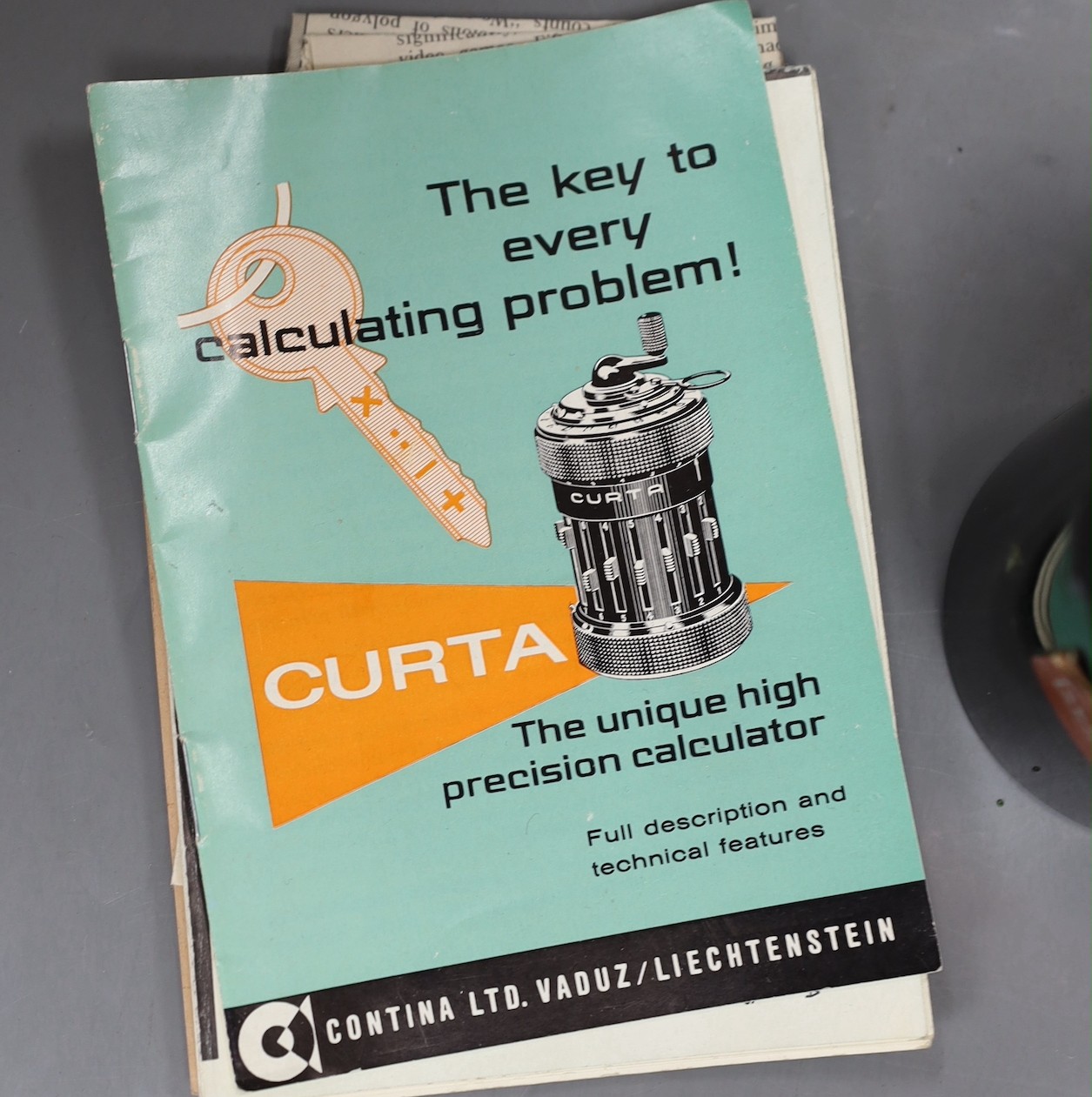A Curta patent calculator serial number 535523, cased with original paperwork, case 12cms high